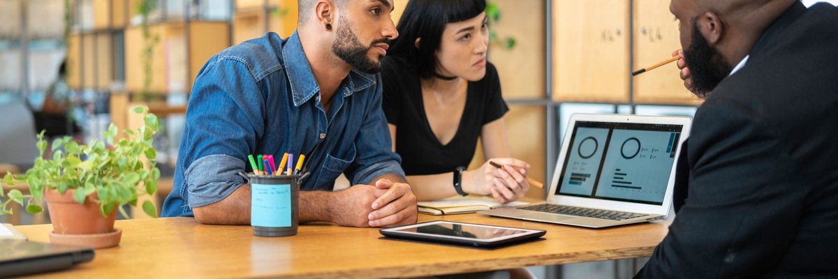 Couple meeting with banker in an office.