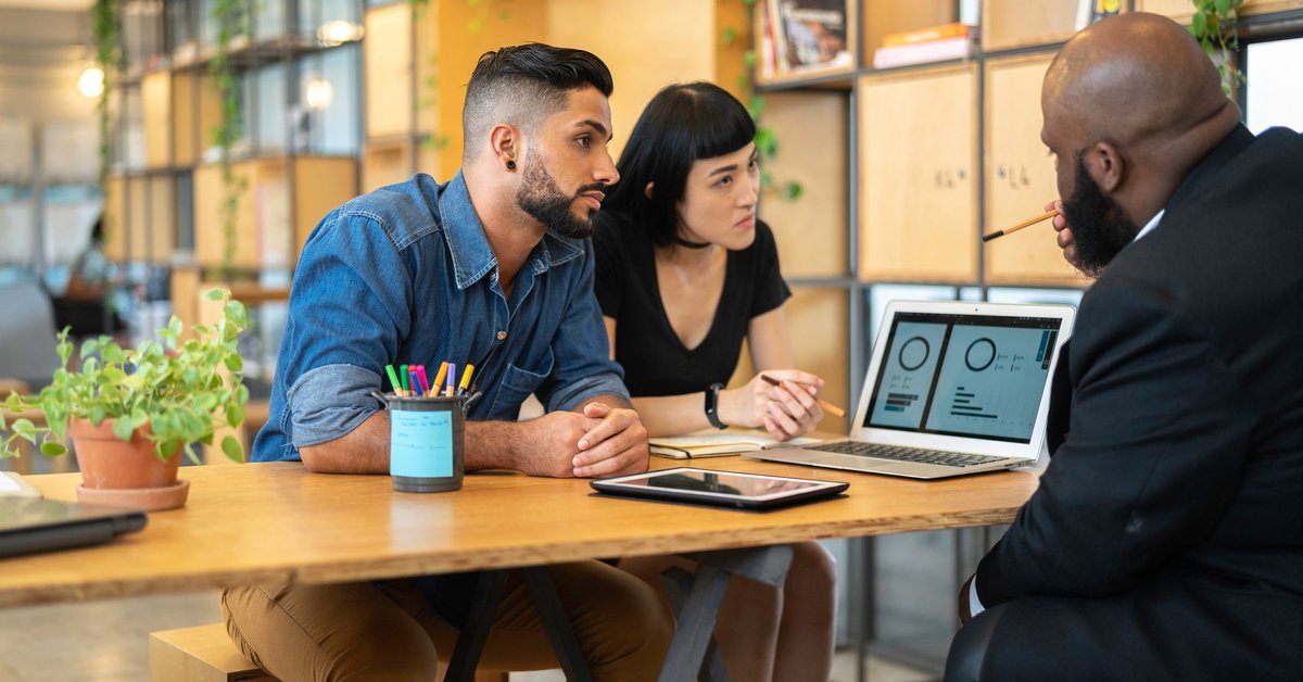 Couple meeting with banker in an office.