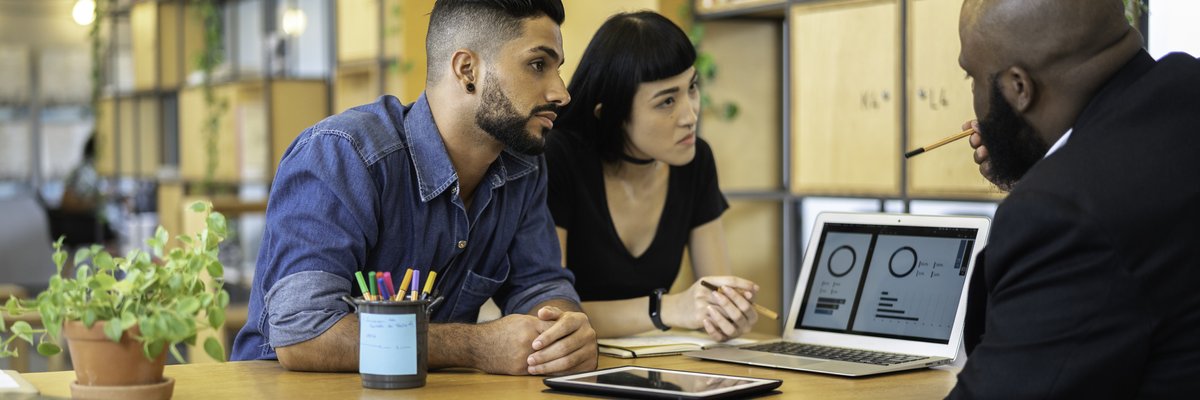 Couple meeting with banker in an office.