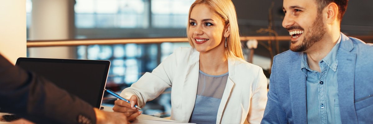 A young couple signing a contract.