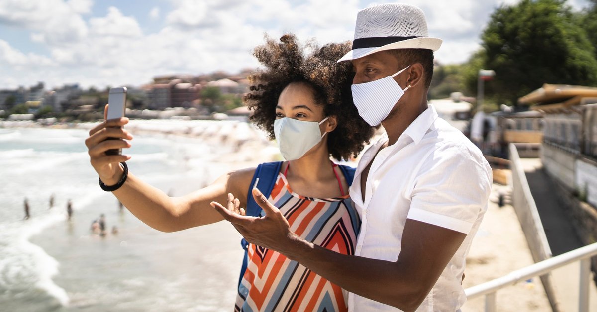 A couple take a selfie outdoors while on a European vacation.