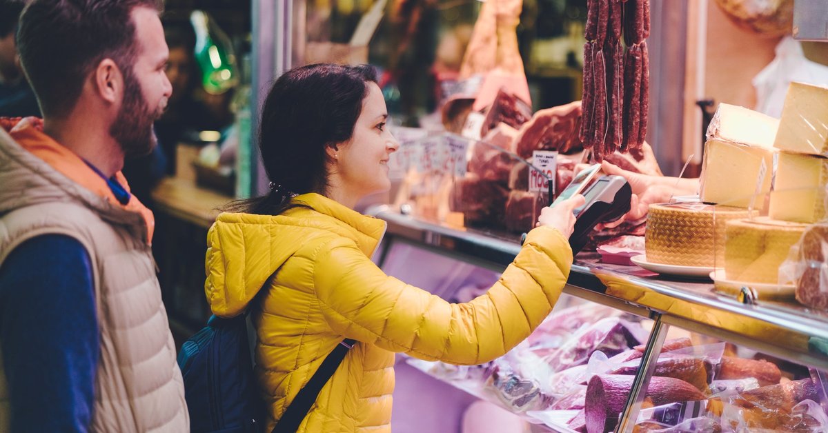 Couple using credit card at farmers market