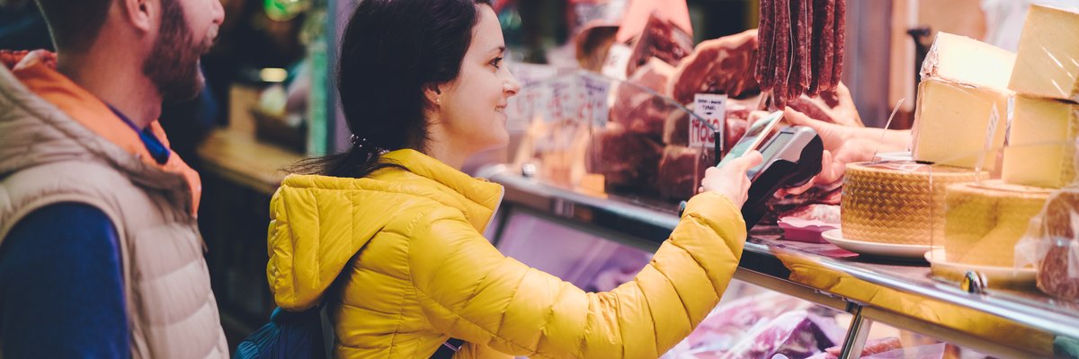 Couple using credit card at farmers market