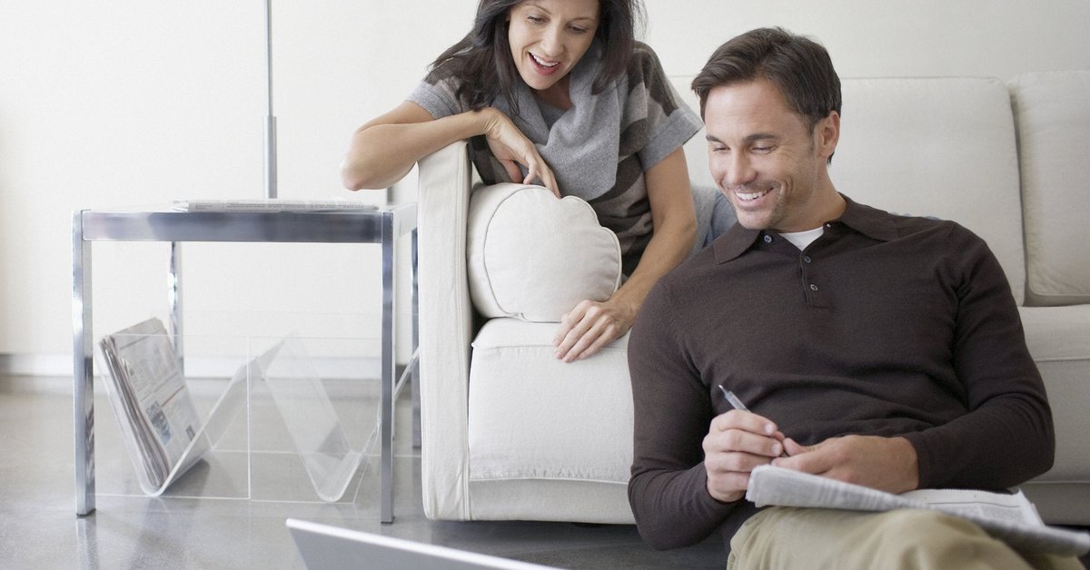 Couple looks at a laptop