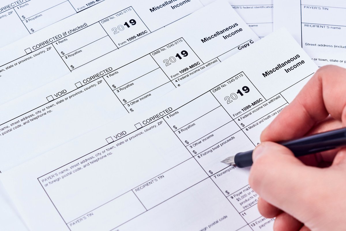 Person filling out a miscellaneous income tax form.