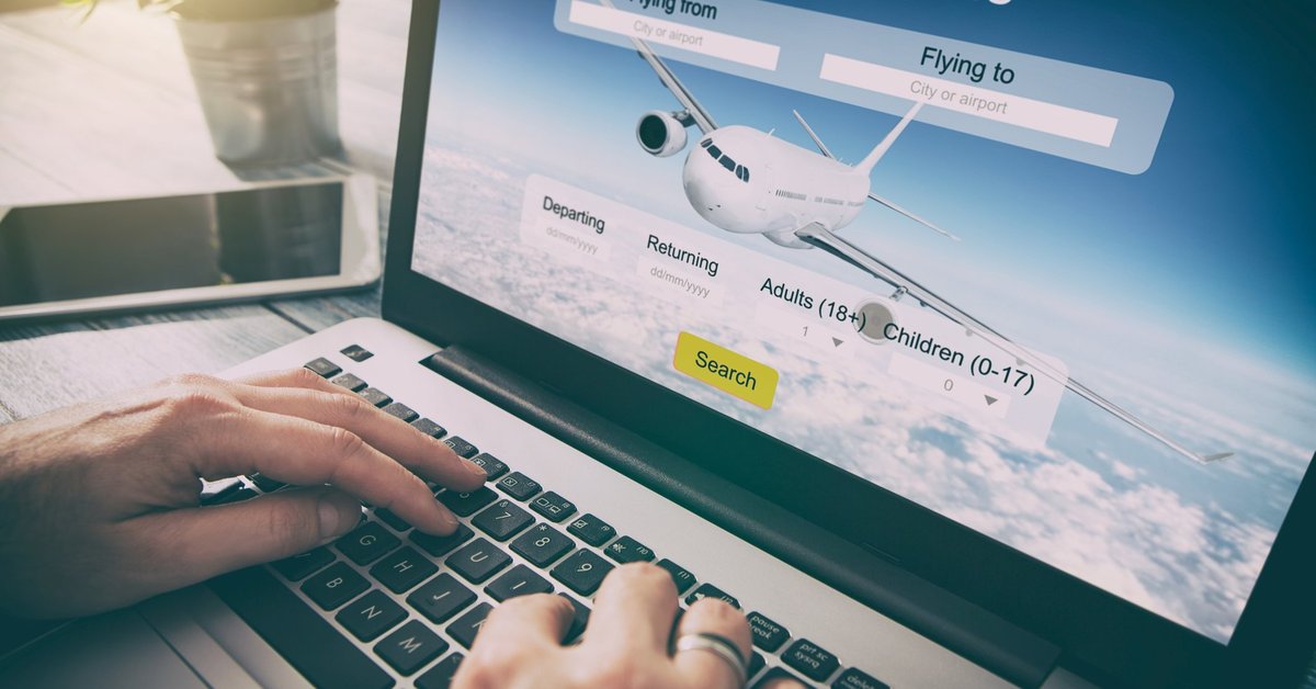 Man using laptop to search for flights.