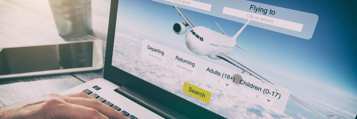 Man using laptop to search for flights.