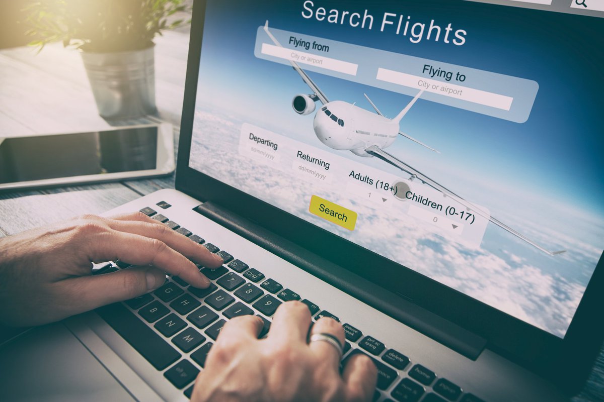 Man using laptop to search for flights.