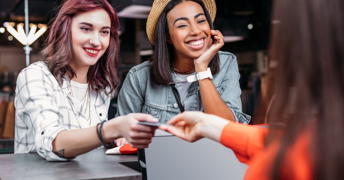 Two people paying for something with a credit card
