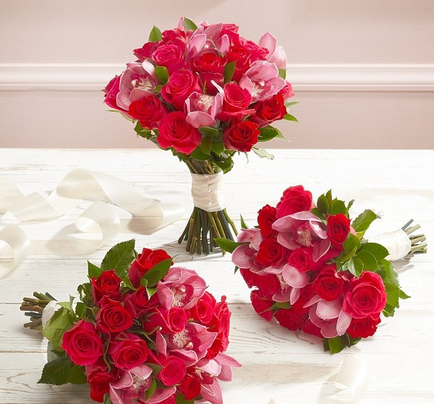 Picture of roses and orchids in three bouquets.