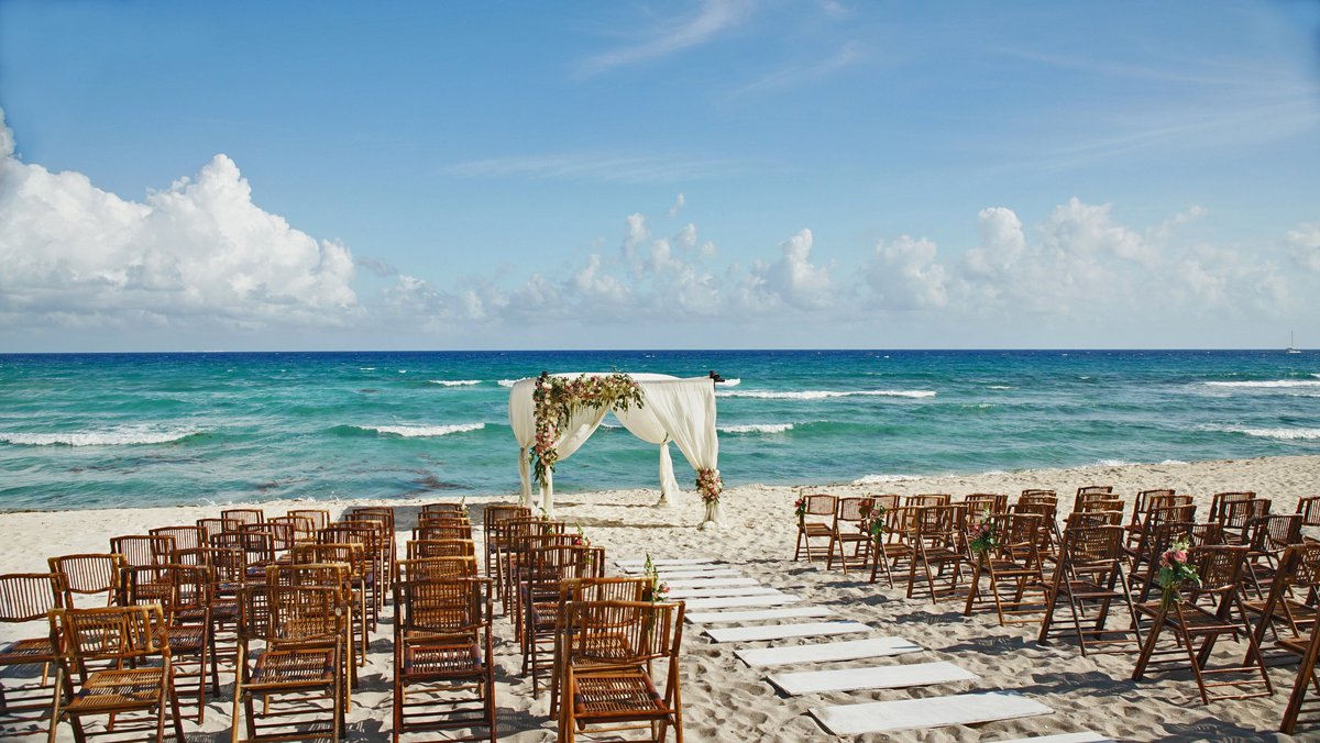 Chairs set up on the beach for a wedding ceremony.