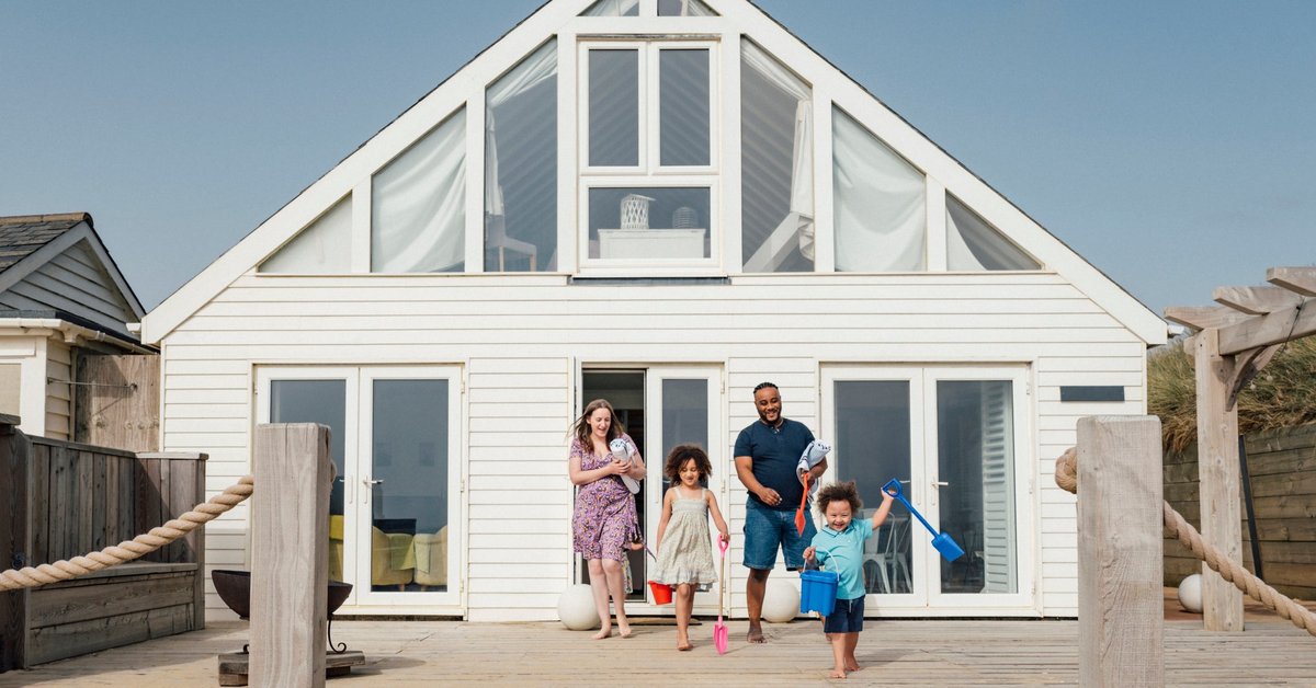 Family emerging from a beach house.