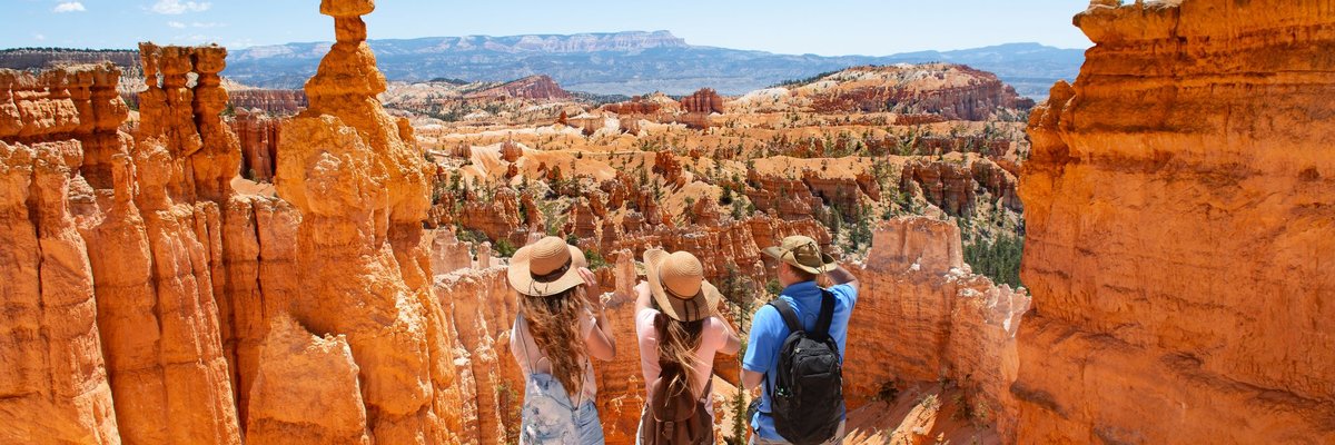 A family taking in the desert view of red rock formations.