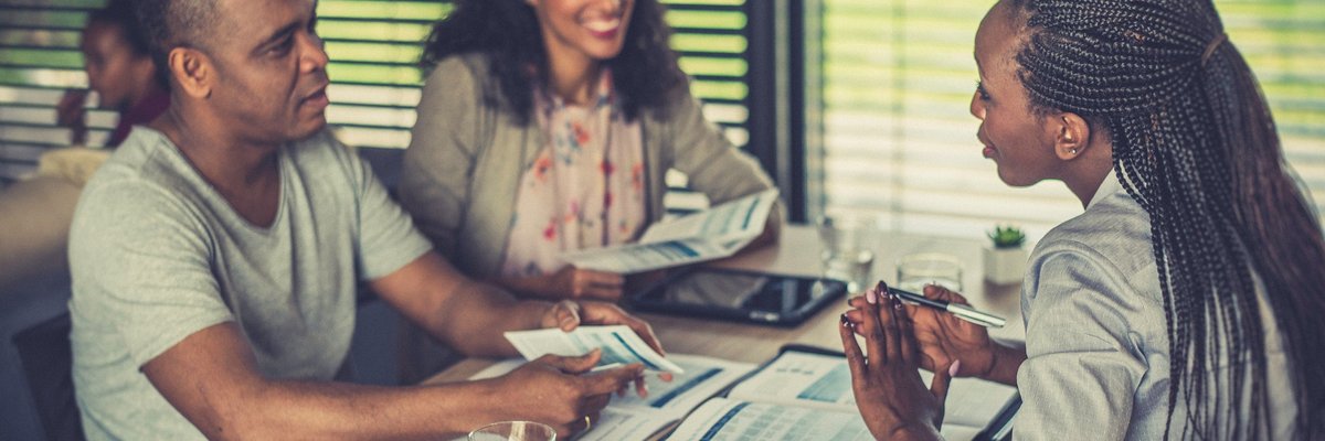 Financial professional talks to couple over paperwork