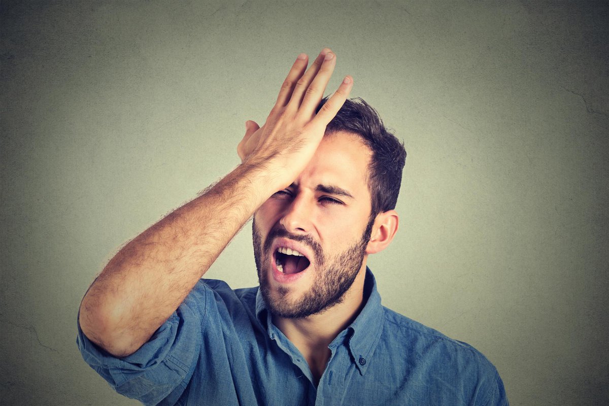 Upset man smacking his forehead with his hand