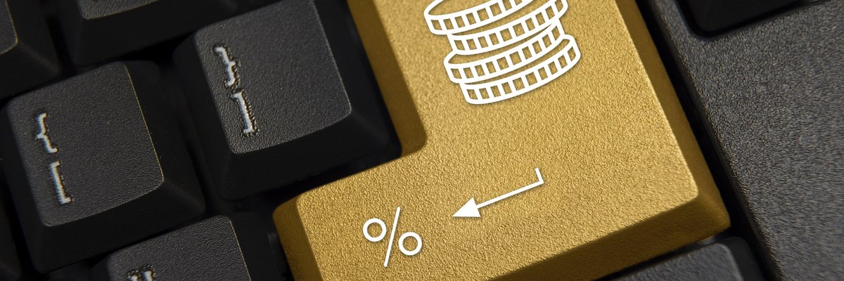 A computer keyboard featuring a golden return key marked with a stack of coins and a percentage sign.