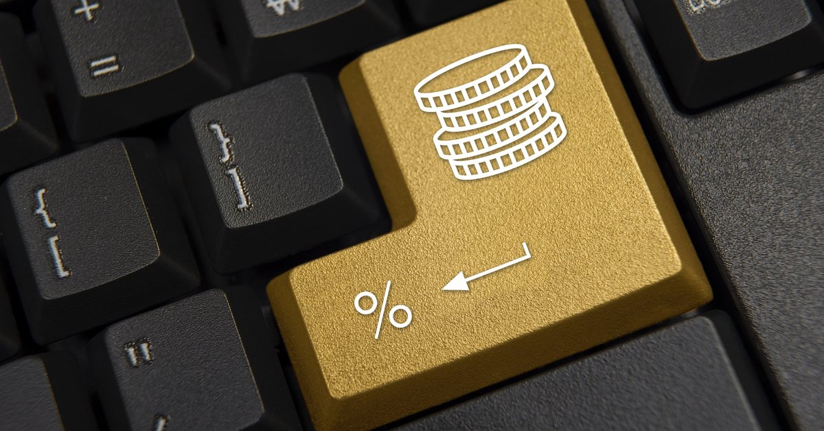 A computer keyboard featuring a golden return key marked with a stack of coins and a percentage sign.