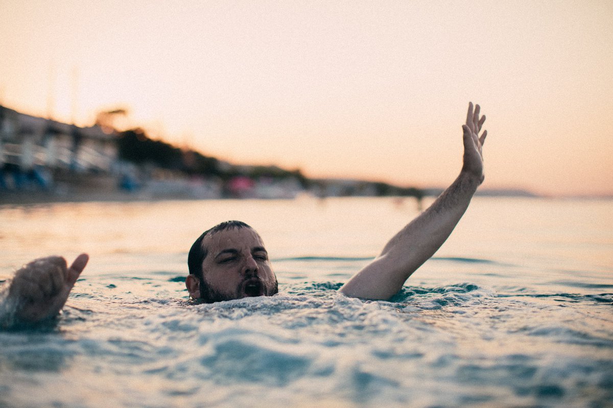 Bearded guy flailing around in the ocean.