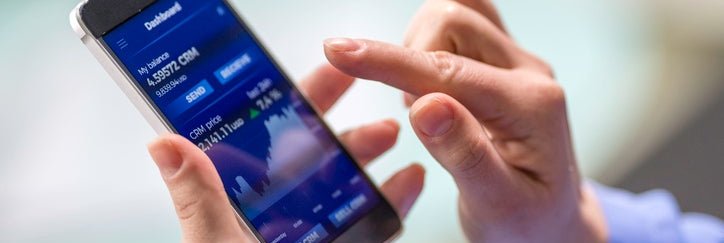 A woman buys cryptocurrency through a mobile phone app.