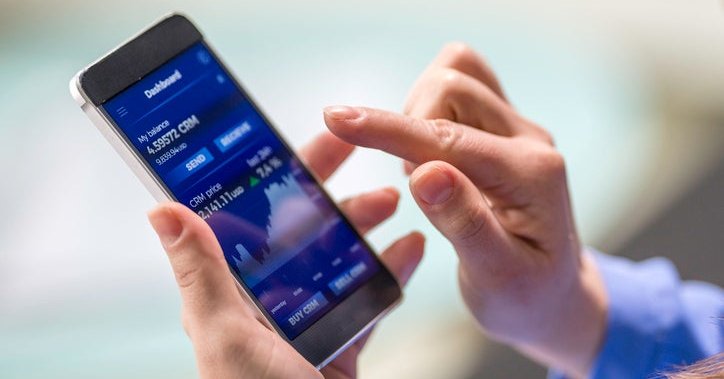 A woman buys cryptocurrency through a mobile phone app.