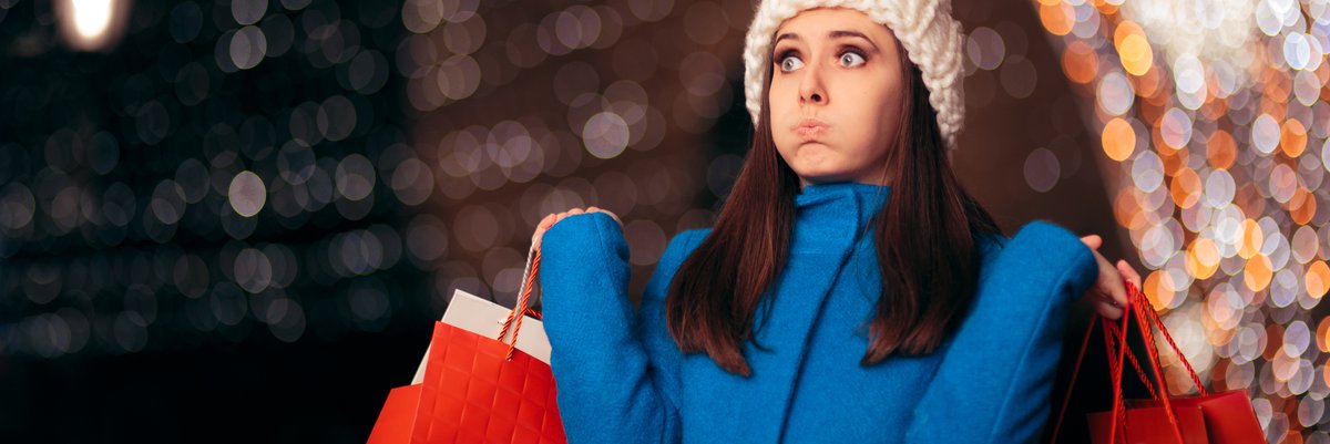 Person visibly stressed while doing holiday shopping.