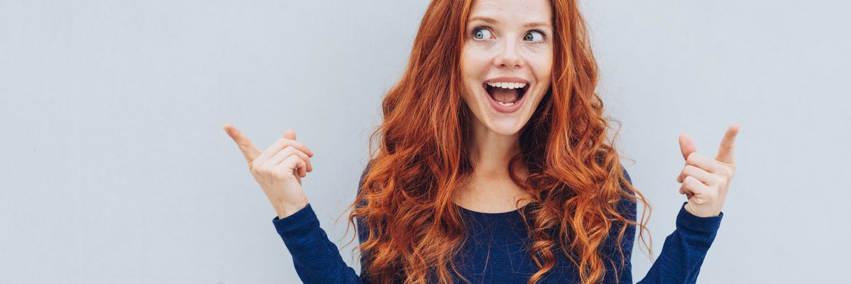 Excited person pointing to something unseen.