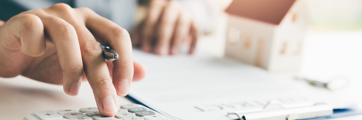 Someone's hands calculating something on a calculator.