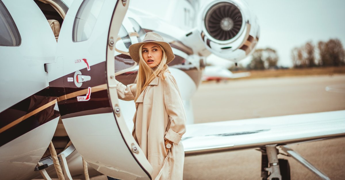Young woman about to step into private plane.