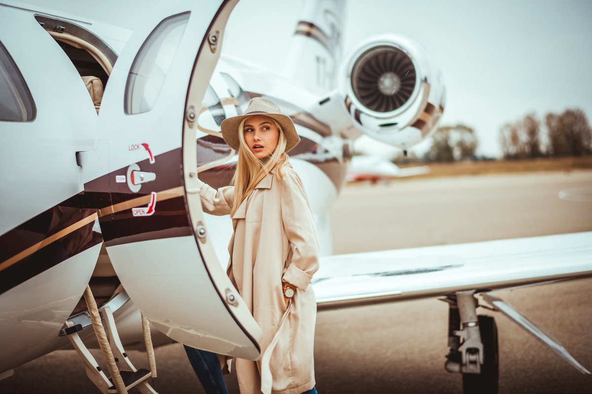 Young woman about to step into private plane.