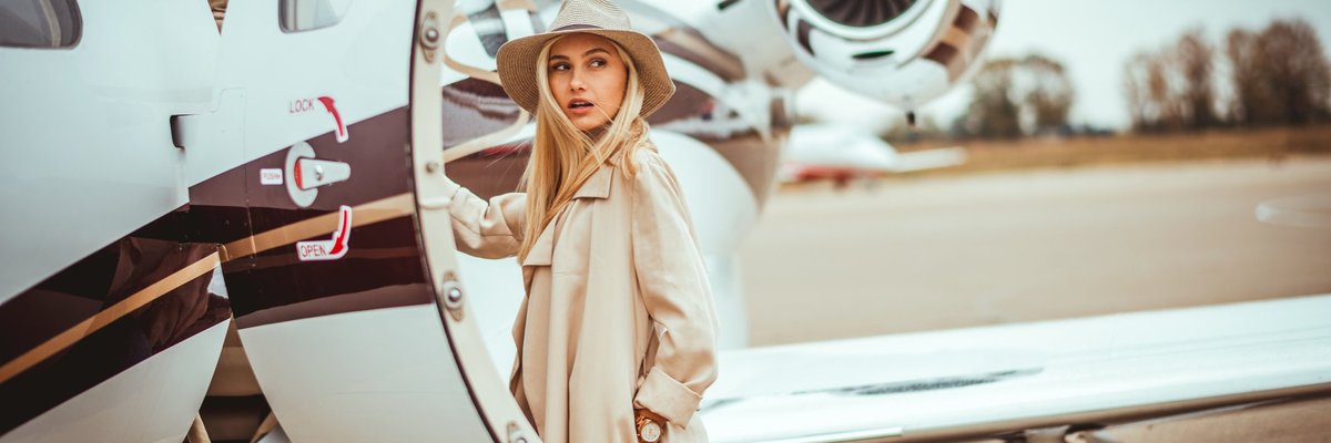 Young woman about to step into private plane.