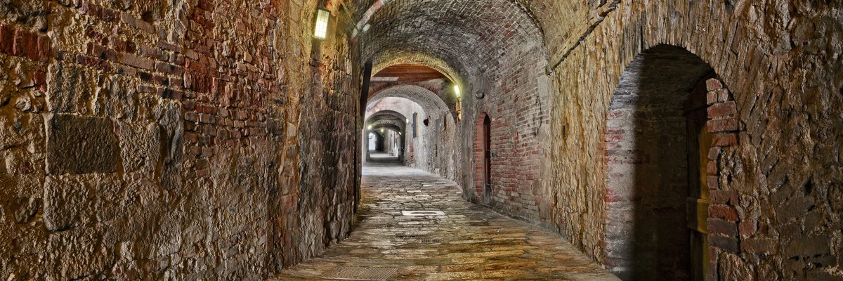 Long hallway through underground catacombs.