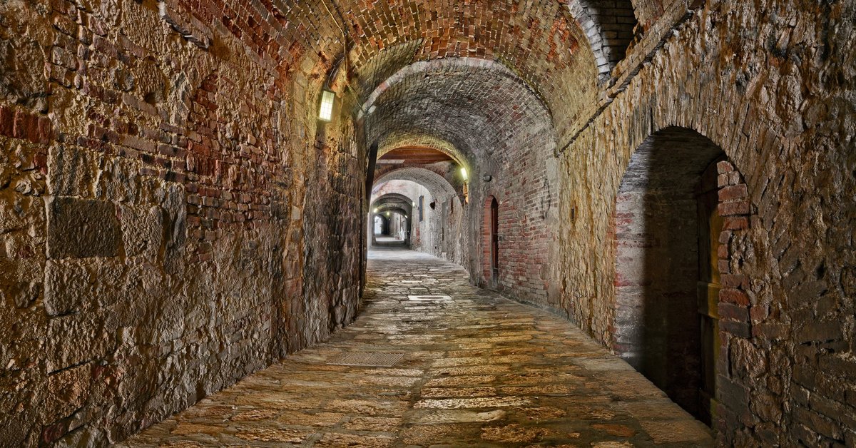 Long hallway through underground catacombs.