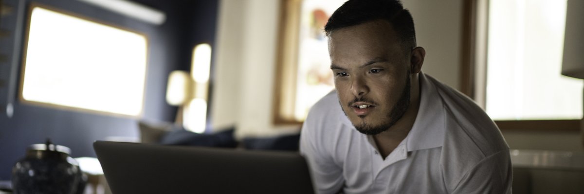 Someone uses a laptop on the couch at home.