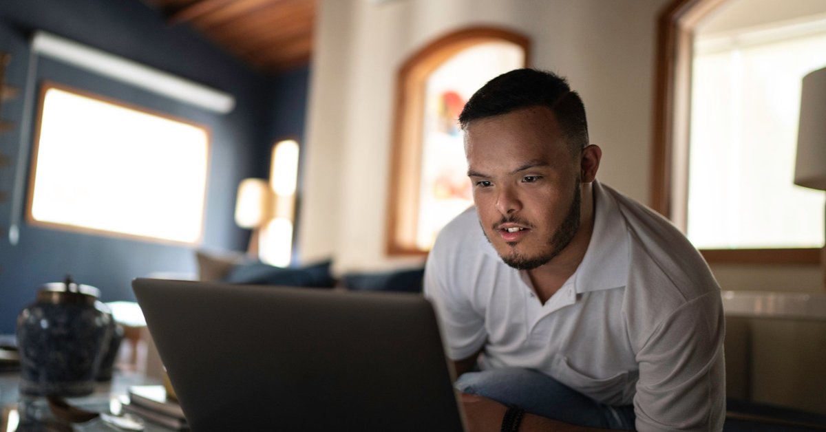 Someone uses a laptop on the couch at home.