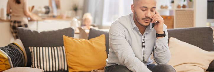 Man on the phone doing paperwork at home