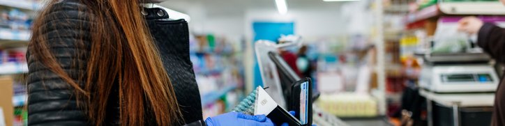 Woman at checkout ready to pay for groceries with credit card.jpg