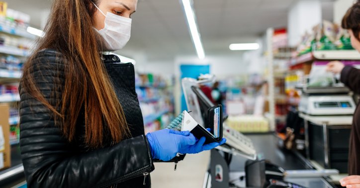 Woman at checkout ready to pay for groceries with credit card.jpg