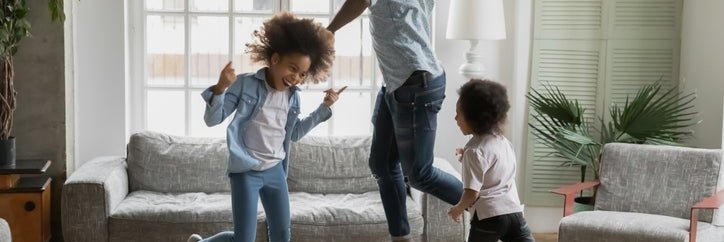 Man and kids dance around new home.