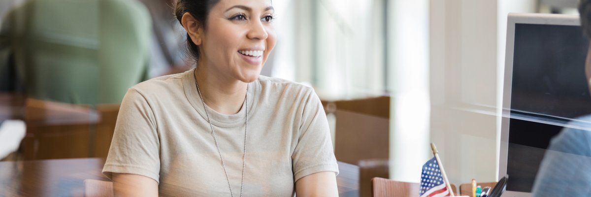 A military veteran meets with a loan officer in an office.