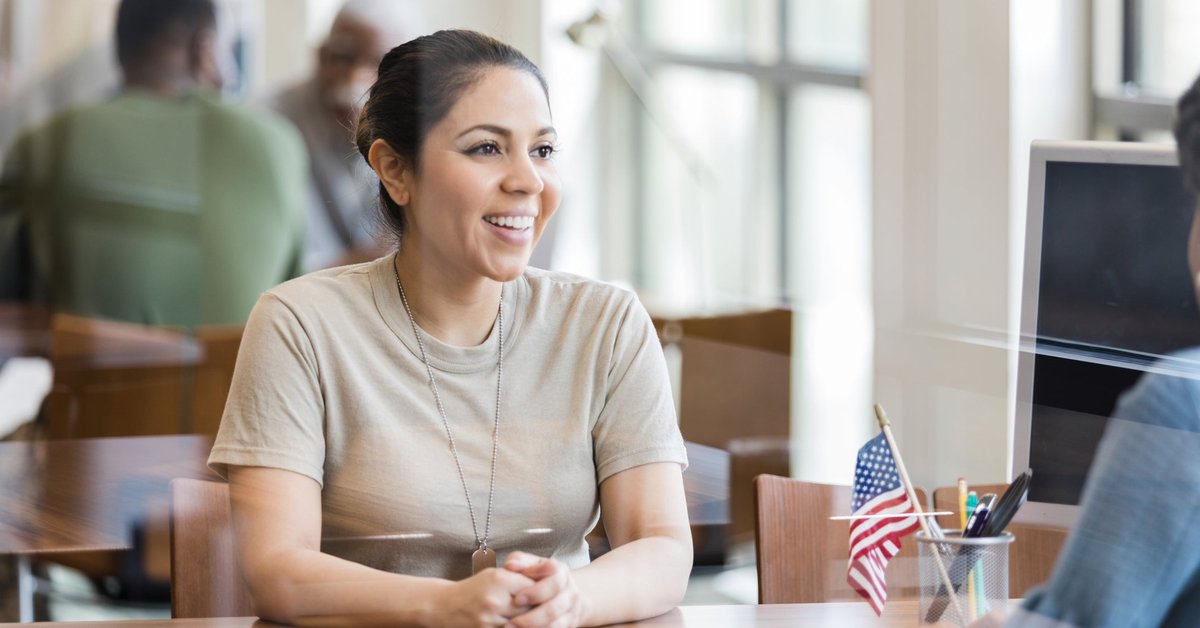 A military veteran meets with a loan officer in an office.
