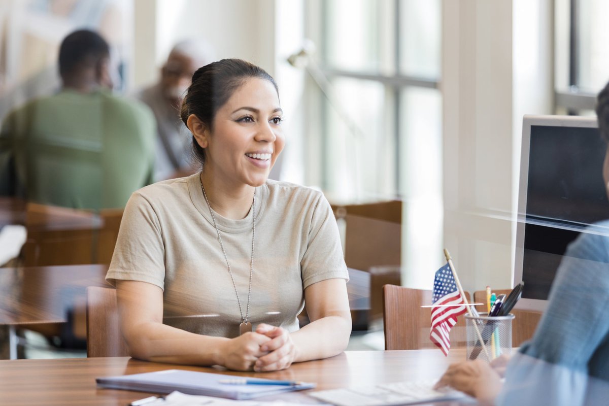 A military veteran meets with a loan officer in an office.