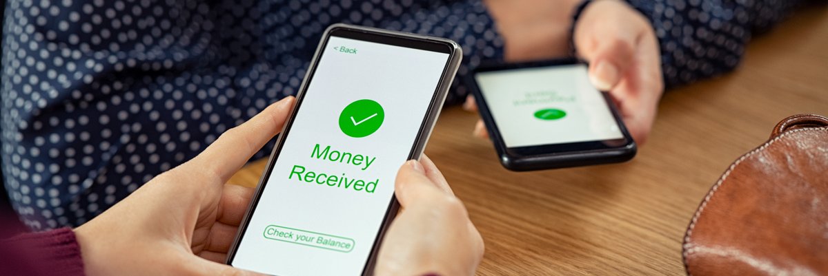 Two people holding cellphones using a payment app to send and receive money.