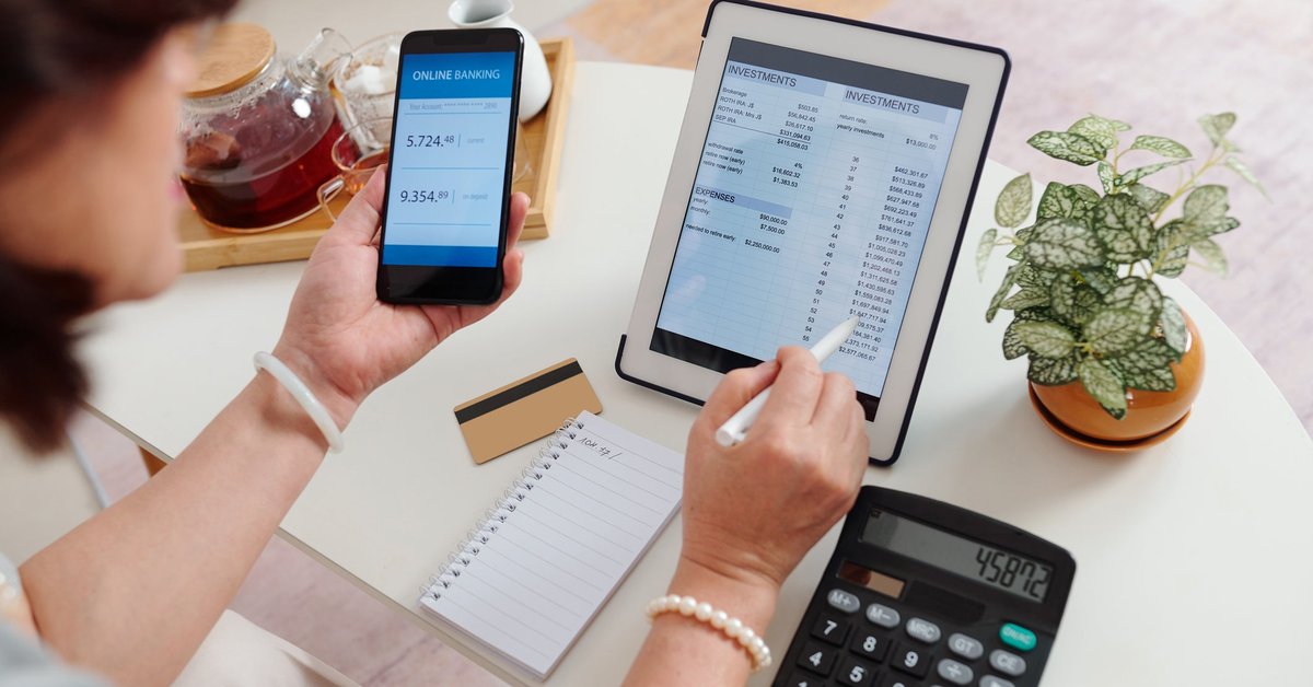 An adult checks their online brokerage account using their tablet and smartphone.