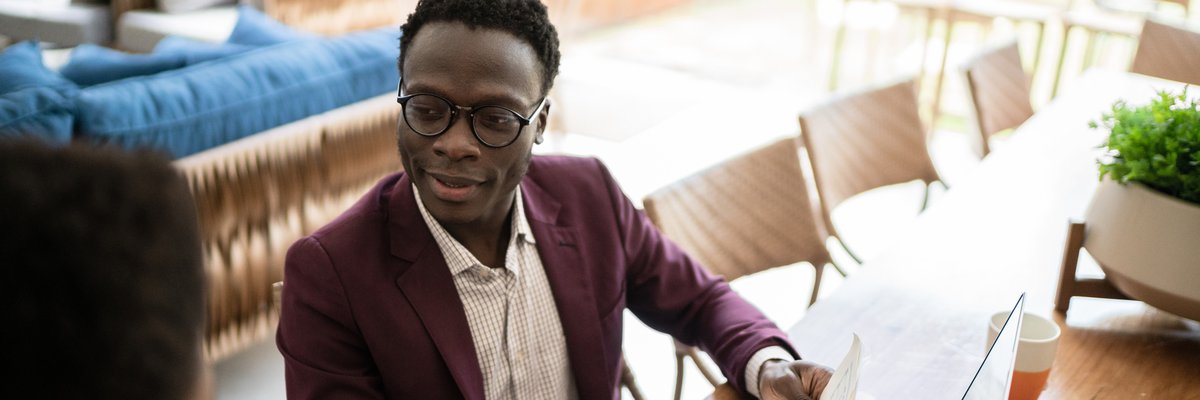 Financial advisor meets with a client in their home.