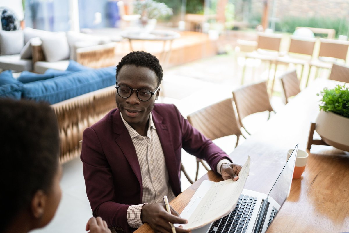 Financial advisor meets with a client in their home.