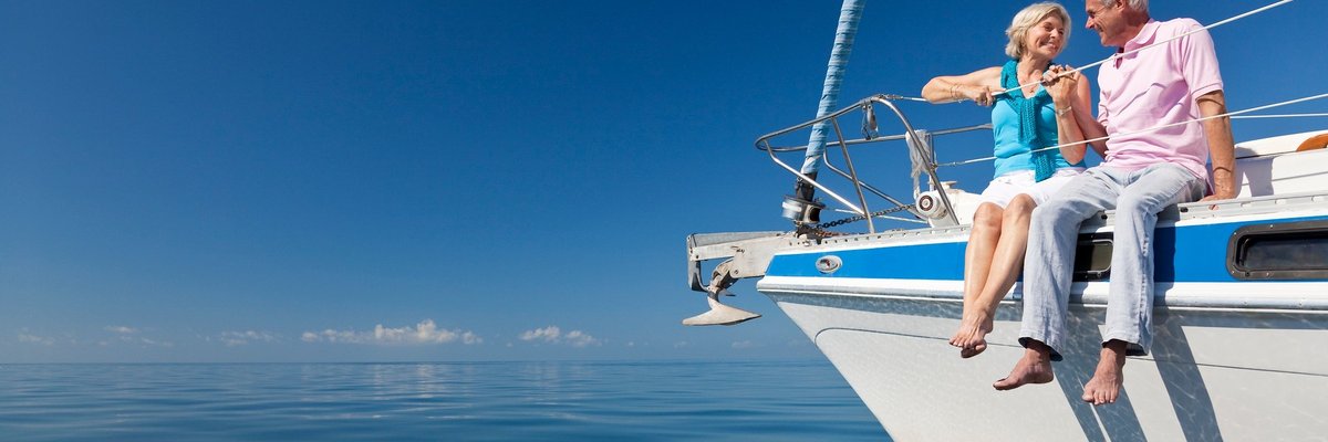 Smiling man and woman sitting on yacht