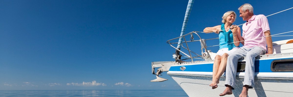 Smiling man and woman sitting on yacht