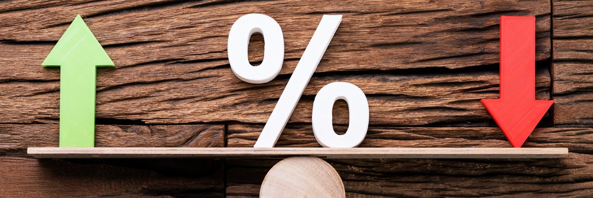 A green up arrow opposite a red down arrow on a level with a percent sign in the middle.