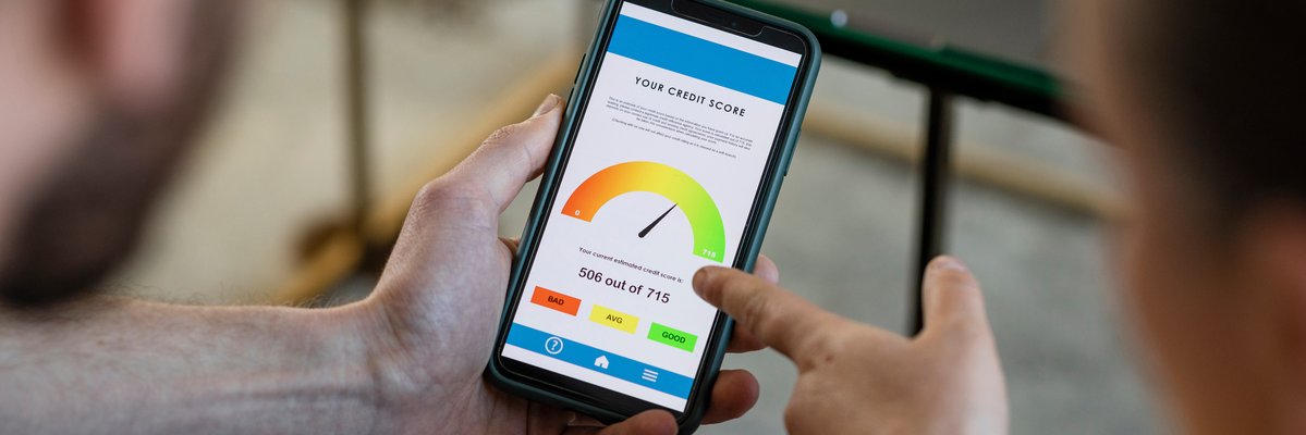 Two people looking at credit score on phone.