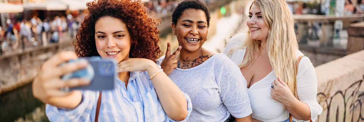 Group of friends take selfie during travels.